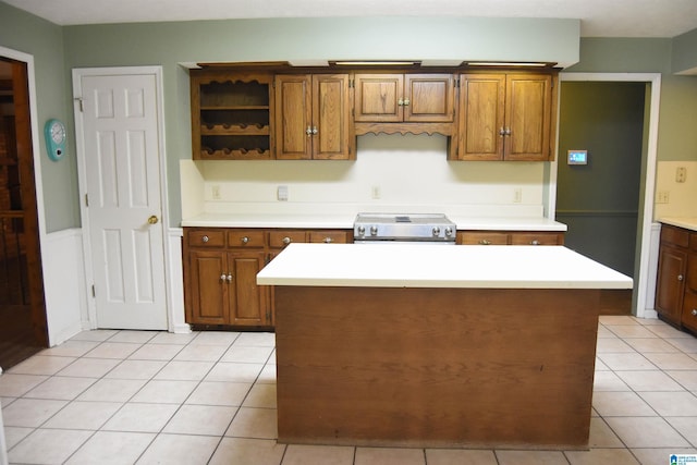 2301 Hathaway Heights Rd, Anniston, AL 36207 - kitchen featuring stainless steel range with electric stovetop, light countertops, open shelves, light tile patterned flooring, and brown cabinets
