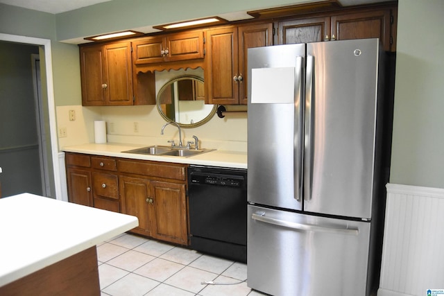 2301 Hathaway Heights Rd, Anniston, AL 36207 - kitchen with freestanding refrigerator, black dishwasher, a sink, and light countertops
