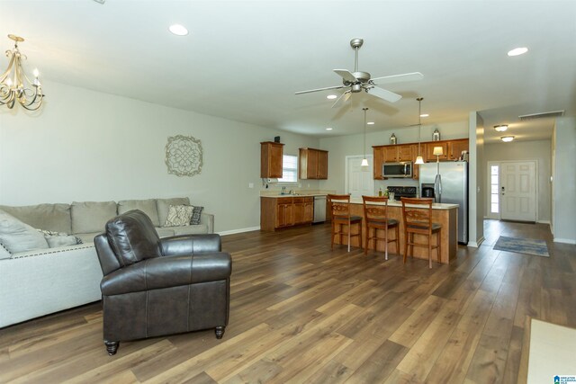 1009 Fairbank Ln, Chelsea, AL 35043 - living room featuring dark wood-style flooring, ceiling fan, recessed lighting, baseboards, and a chandelier