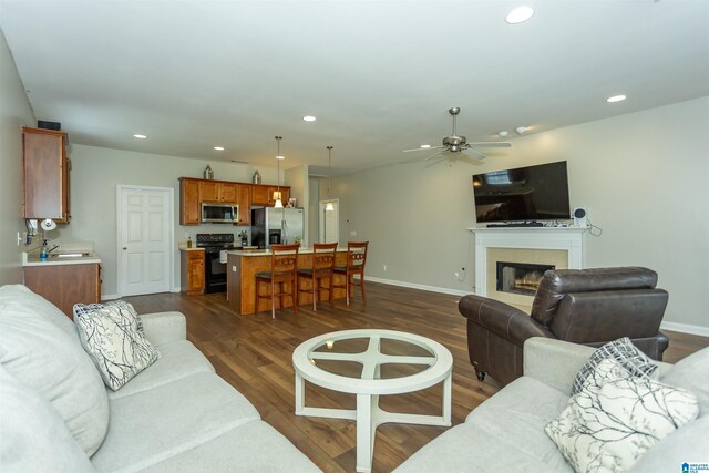 1009 Fairbank Ln, Chelsea, AL 35043 - living area featuring dark wood-type flooring, recessed lighting, a ceiling fan, baseboards, and a fireplace