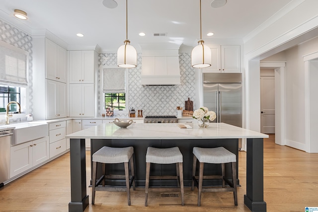3 Troon, Birmingham, AL 35242 - kitchen with a sink, appliances with stainless steel finishes, white cabinetry, a kitchen breakfast bar, and ornamental molding
