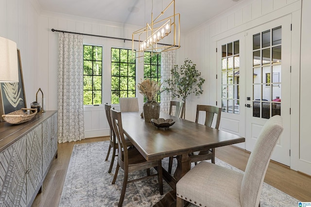 3 Troon, Birmingham, AL 35242 - dining area featuring crown molding, light wood-style floors, french doors, a decorative wall, and a chandelier