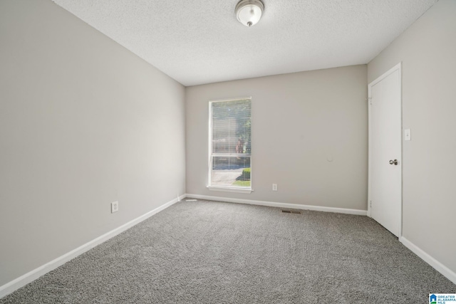 1056 Cardinal Cir, Hueytown, AL 35023 - empty room featuring carpet floors, a textured ceiling, and baseboards