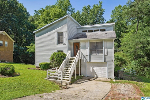 1056 Cardinal Cir, Hueytown, AL 35023 - split level home with driveway, a front yard, an attached garage, roof with shingles, and stairs