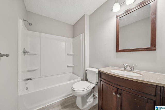 1056 Cardinal Cir, Hueytown, AL 35023 - full bath featuring vanity, toilet, wood finished floors, a textured ceiling, and shower / washtub combination