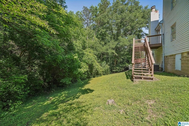 1056 Cardinal Cir, Hueytown, AL 35023 - view of grassy yard with stairs, central air condition unit, and a deck