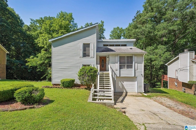 1056 Cardinal Cir, Hueytown, AL 35023 - view of front of house featuring driveway, a front yard, a garage, and stairs