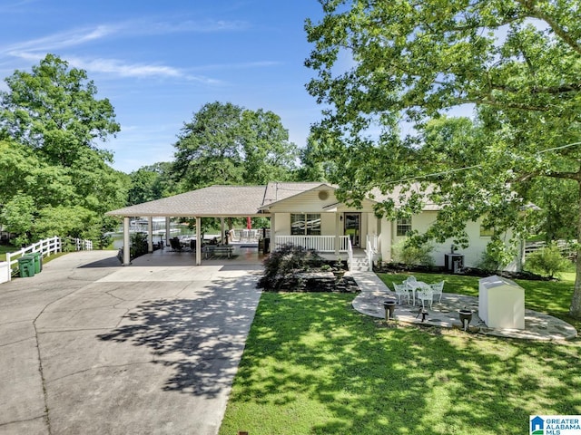 14 County Road 279, Cullman, AL 35057 - view of front of property featuring a front lawn, concrete driveway, a carport, stucco siding, and covered porch
