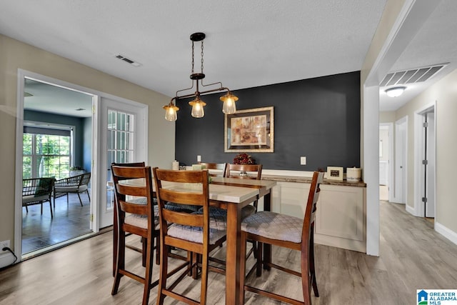 14 County Road 279, Cullman, AL 35057 - dining area with light wood-style flooring, a textured ceiling, and baseboards