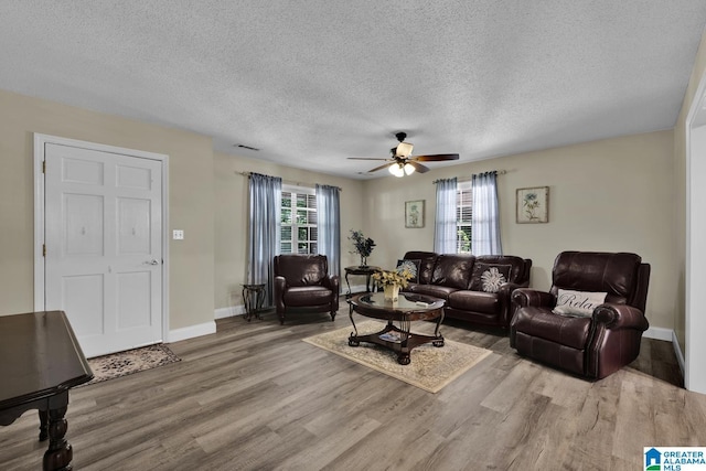 14 County Road 279, Cullman, AL 35057 - living room with wood finished floors, a ceiling fan, a textured ceiling, and baseboards
