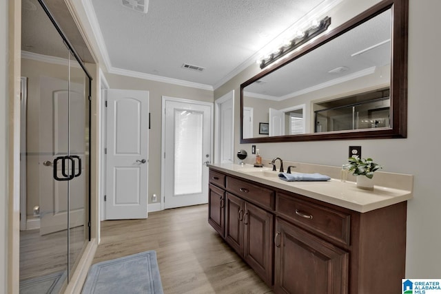 14 County Road 279, Cullman, AL 35057 - bathroom with a stall shower, vanity, wood finished floors, a textured ceiling, and crown molding