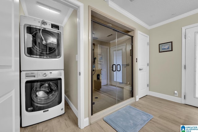 14 County Road 279, Cullman, AL 35057 - laundry area with stacked washer and clothes dryer, wood finished floors, ornamental molding, and baseboards