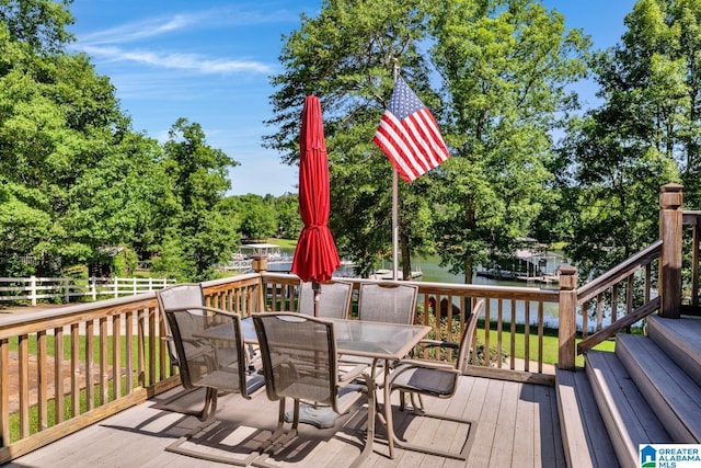 14 County Road 279, Cullman, AL 35057 - wooden terrace with outdoor dining space, view of wooded area, and a water view