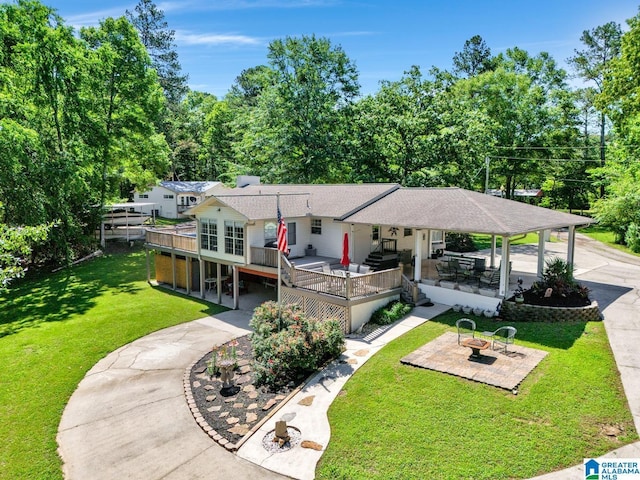 14 County Road 279, Cullman, AL 35057 - view of front of house featuring an outdoor fire pit, driveway, a patio, a deck, and a front lawn