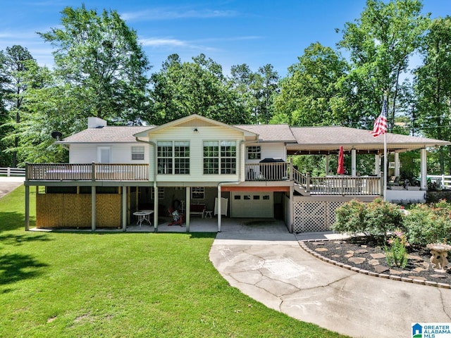 14 County Road 279, Cullman, AL 35057 - back of property featuring a garage, driveway, a wooden deck, a yard, and a shingled roof