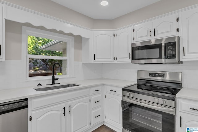 7300 6th Ave S, Birmingham, AL 35206 - kitchen featuring appliances with stainless steel finishes, a sink, white cabinetry, decorative backsplash, and light countertops