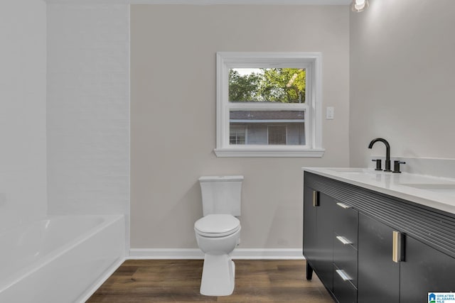 7300 6th Ave S, Birmingham, AL 35206 - bathroom with baseboards, double vanity, wood finished floors, toilet, and shower / washtub combination