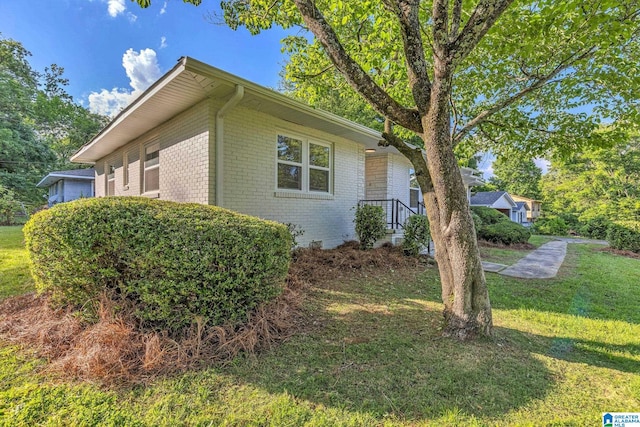 7300 6th Ave S, Birmingham, AL 35206 - view of property exterior featuring brick siding and a yard