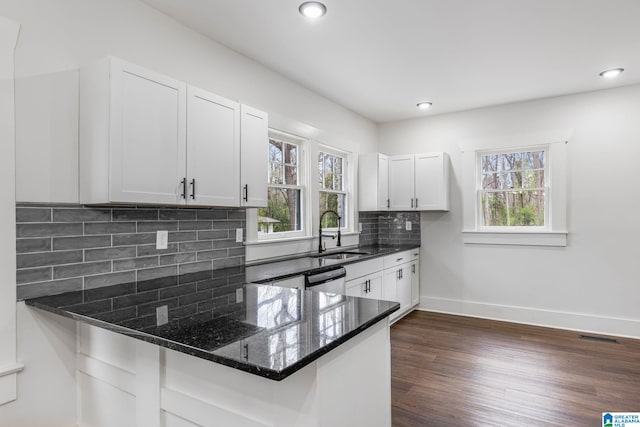 3010 15th St, Ensley, Birmingham, AL 35208 - kitchen with dark stone countertops, a sink, dark wood-style flooring, baseboards, and white cabinetry
