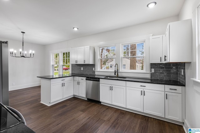 3010 15th St, Ensley, Birmingham, AL 35208 - kitchen with stainless steel dishwasher, a peninsula, dark wood-style flooring, a chandelier, and recessed lighting