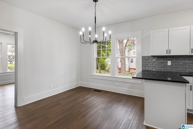 3010 15th St, Ensley, Birmingham, AL 35208 - unfurnished dining area featuring dark wood finished floors, plenty of natural light, a chandelier, and baseboards