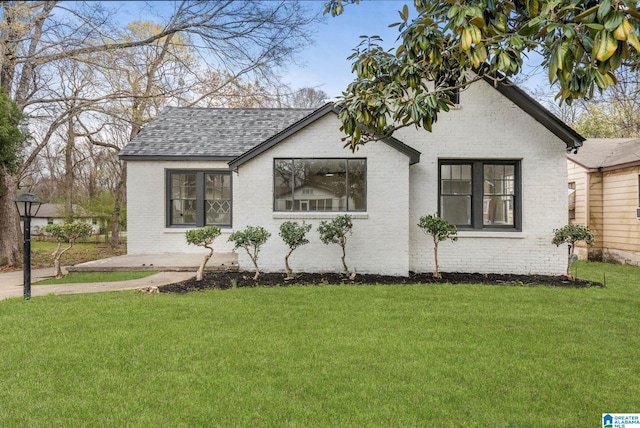 3010 15th St, Ensley, Birmingham, AL 35208 - view of front of house with brick siding, a front lawn, and roof with shingles