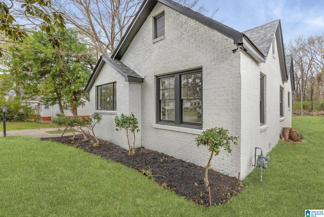 3010 15th St, Ensley, Birmingham, AL 35208 - view of side of property featuring roof with shingles, brick siding, and a yard