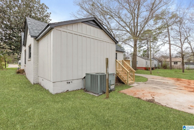3010 15th St, Ensley, Birmingham, AL 35208 - view of home's exterior featuring a shingled roof, crawl space, central air condition unit, board and batten siding, and a yard