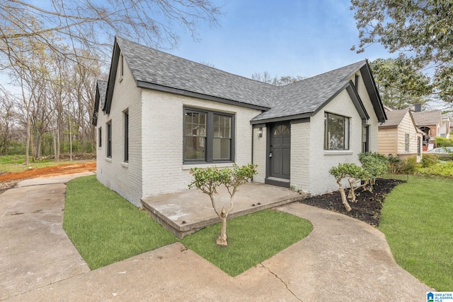 3010 15th St, Ensley, Birmingham, AL 35208 - view of front facade featuring a shingled roof, brick siding, and a front lawn