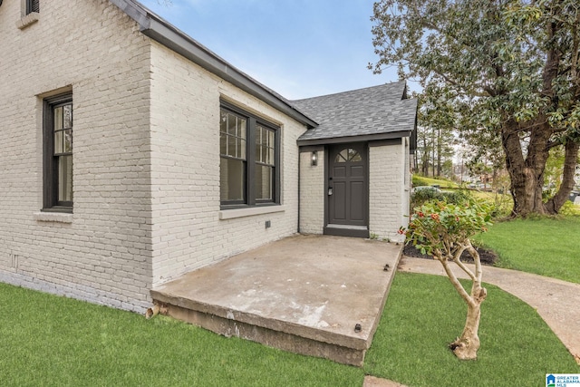3010 15th St, Ensley, Birmingham, AL 35208 - entrance to property with brick siding, a shingled roof, and a lawn