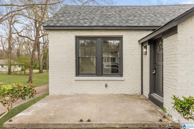 3010 15th St, Ensley, Birmingham, AL 35208 - doorway to property with a patio area, roof with shingles, and brick siding