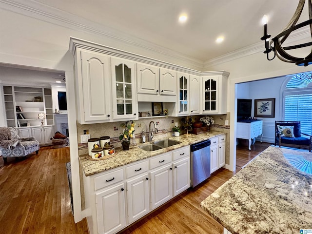 200 Quail Ridge Rd, Oneonta, AL 35121 - kitchen with stainless steel dishwasher, a sink, ornamental molding, light stone counters, and decorative backsplash