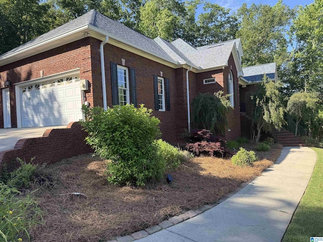 200 Quail Ridge Rd, Oneonta, AL 35121 - view of property exterior featuring brick siding, a shingled roof, and an attached garage