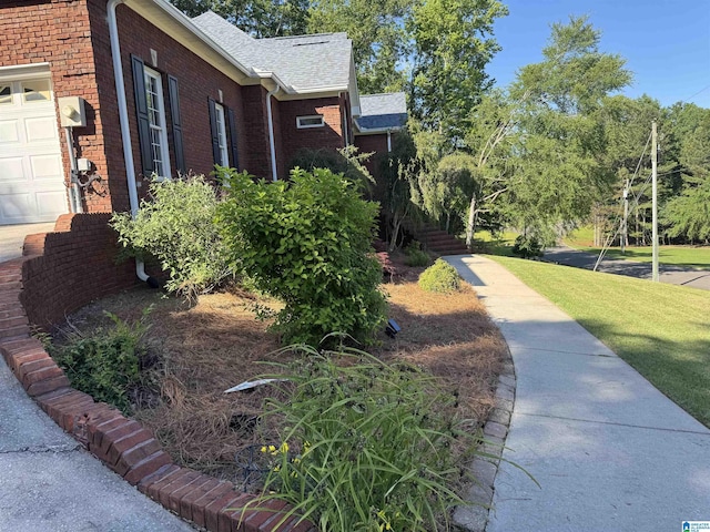 200 Quail Ridge Rd, Oneonta, AL 35121 - view of property exterior with brick siding, a shingled roof, and a lawn