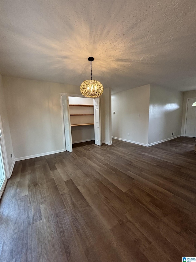 913 Alexandria Rd, Weaver, AL 36277 - unfurnished dining area featuring dark wood-style flooring, a chandelier, and baseboards