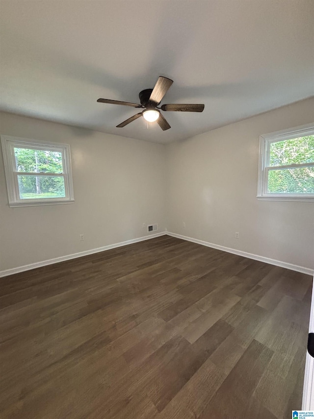 913 Alexandria Rd, Weaver, AL 36277 - empty room with a ceiling fan, dark wood-type flooring, and baseboards