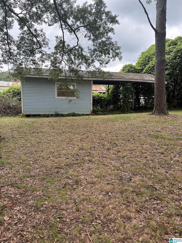 913 Alexandria Rd, Weaver, AL 36277 - view of grassy yard featuring an attached carport