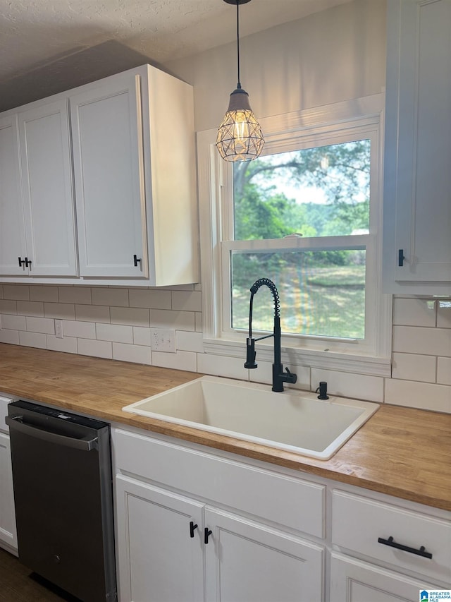 913 Alexandria Rd, Weaver, AL 36277 - kitchen with stainless steel dishwasher, wood counters, a sink, and backsplash