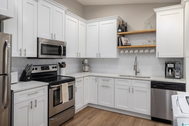 1345 Cresthill Rd, Birmingham, AL 35213 - kitchen featuring stainless steel appliances, a sink, light countertops, backsplash, and white cabinets