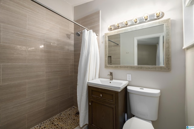 1345 Cresthill Rd, Birmingham, AL 35213 - bathroom with tiled shower, vanity, and toilet