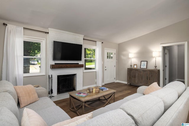 1345 Cresthill Rd, Birmingham, AL 35213 - living room featuring vaulted ceiling, healthy amount of natural light, wood finished floors, a brick fireplace, and baseboards