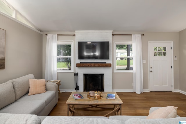 1345 Cresthill Rd, Birmingham, AL 35213 - living room with wood finished floors, a fireplace, vaulted ceiling, and baseboards