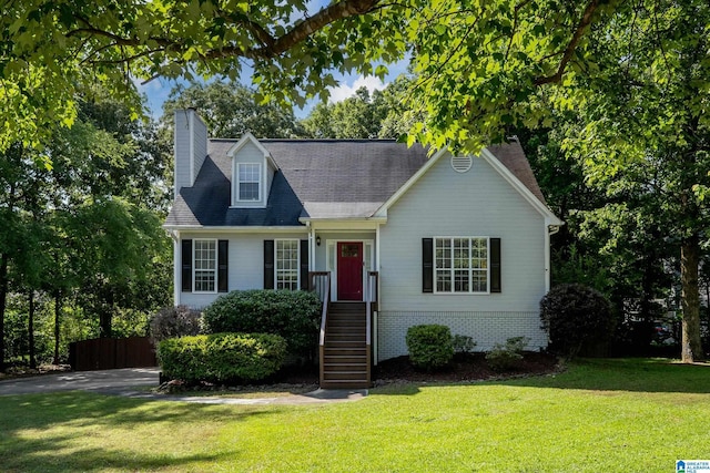 204 Forest Pkwy, Alabaster, AL 35007 - cape cod house featuring a chimney, a front yard, and brick siding