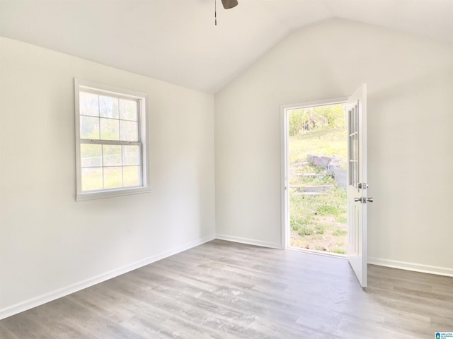 2723 6th St NE, Center Point, AL 35215 - empty room with wood finished floors, vaulted ceiling, ceiling fan, and baseboards