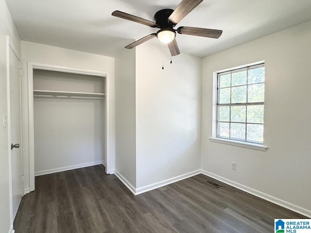 2723 6th St NE, Center Point, AL 35215 - unfurnished bedroom featuring dark wood-type flooring, a closet, baseboards, and ceiling fan