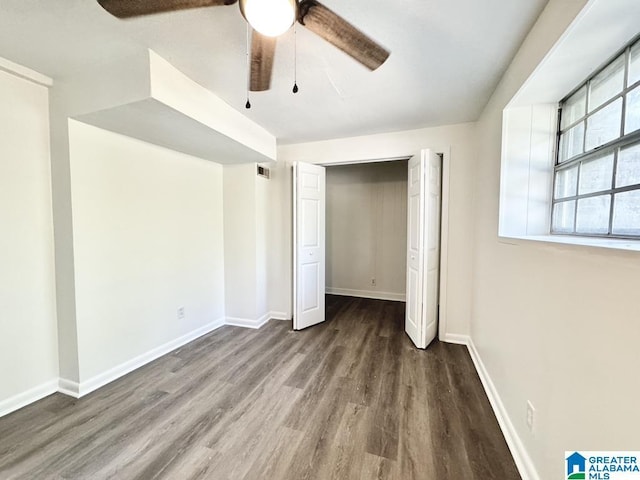 2723 6th St NE, Center Point, AL 35215 - unfurnished bedroom with wood finished floors, baseboards, a closet, and ceiling fan