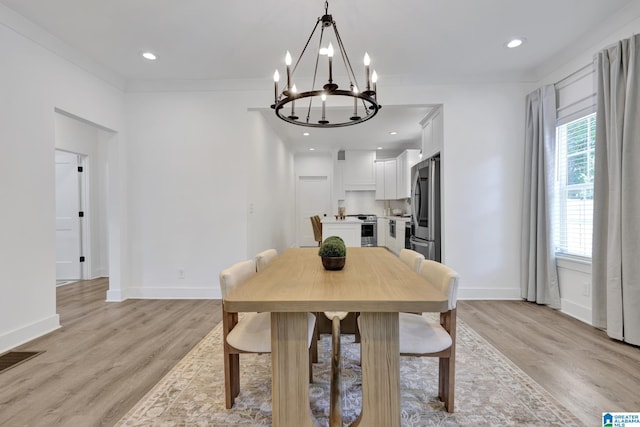 1505 36th St N, Birmingham, AL 35234 - dining room featuring a chandelier, light wood-type flooring, baseboards, and ornamental molding