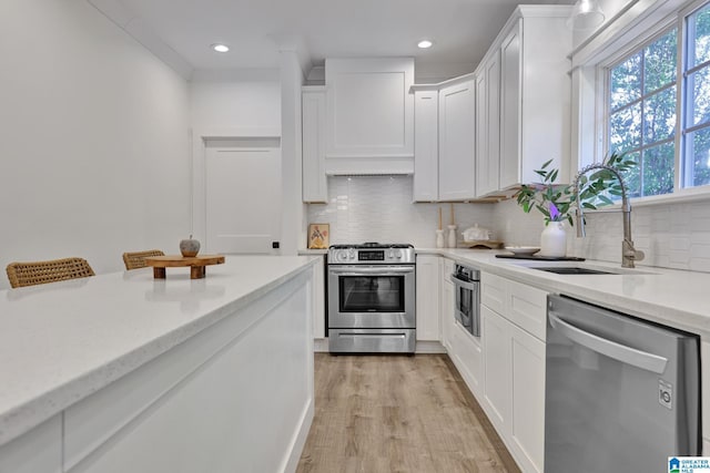 1505 36th St N, Birmingham, AL 35234 - kitchen featuring appliances with stainless steel finishes, a sink, healthy amount of natural light, custom exhaust hood, and recessed lighting
