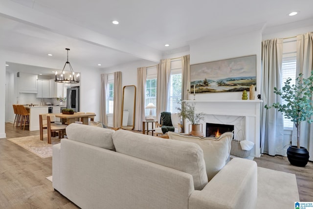 1505 36th St N, Birmingham, AL 35234 - living area with a premium fireplace, light wood-type flooring, recessed lighting, a chandelier, and beamed ceiling