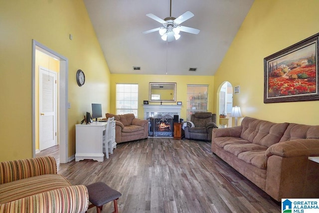 1937 Riva Ridge Rd, Helena, AL 35080 - living room featuring high vaulted ceiling, a ceiling fan, a warm lit fireplace, wood finished floors, and arched walkways